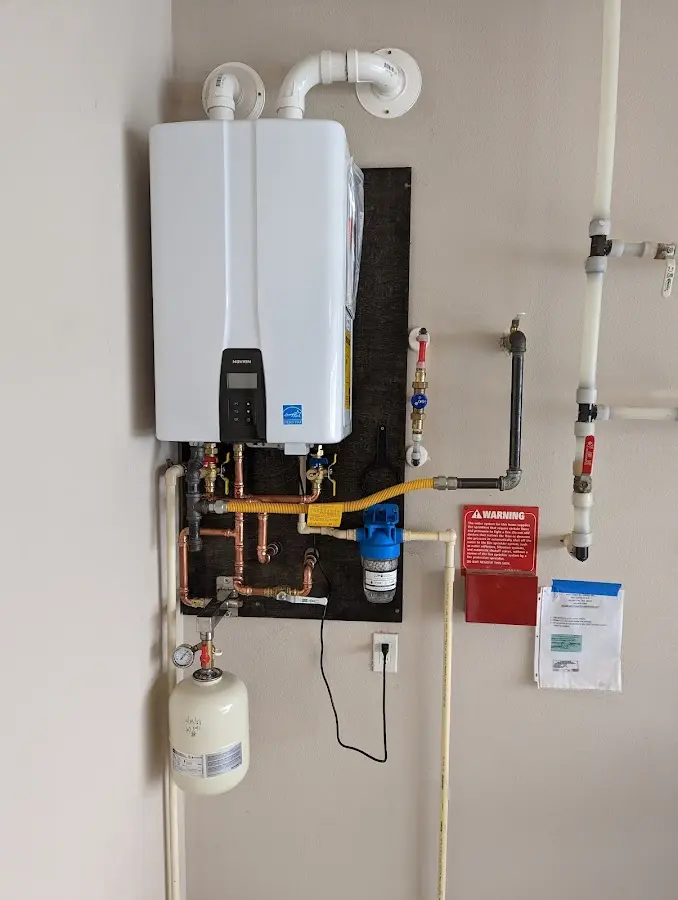 Professional plumber installing copper piping in a Chandler home